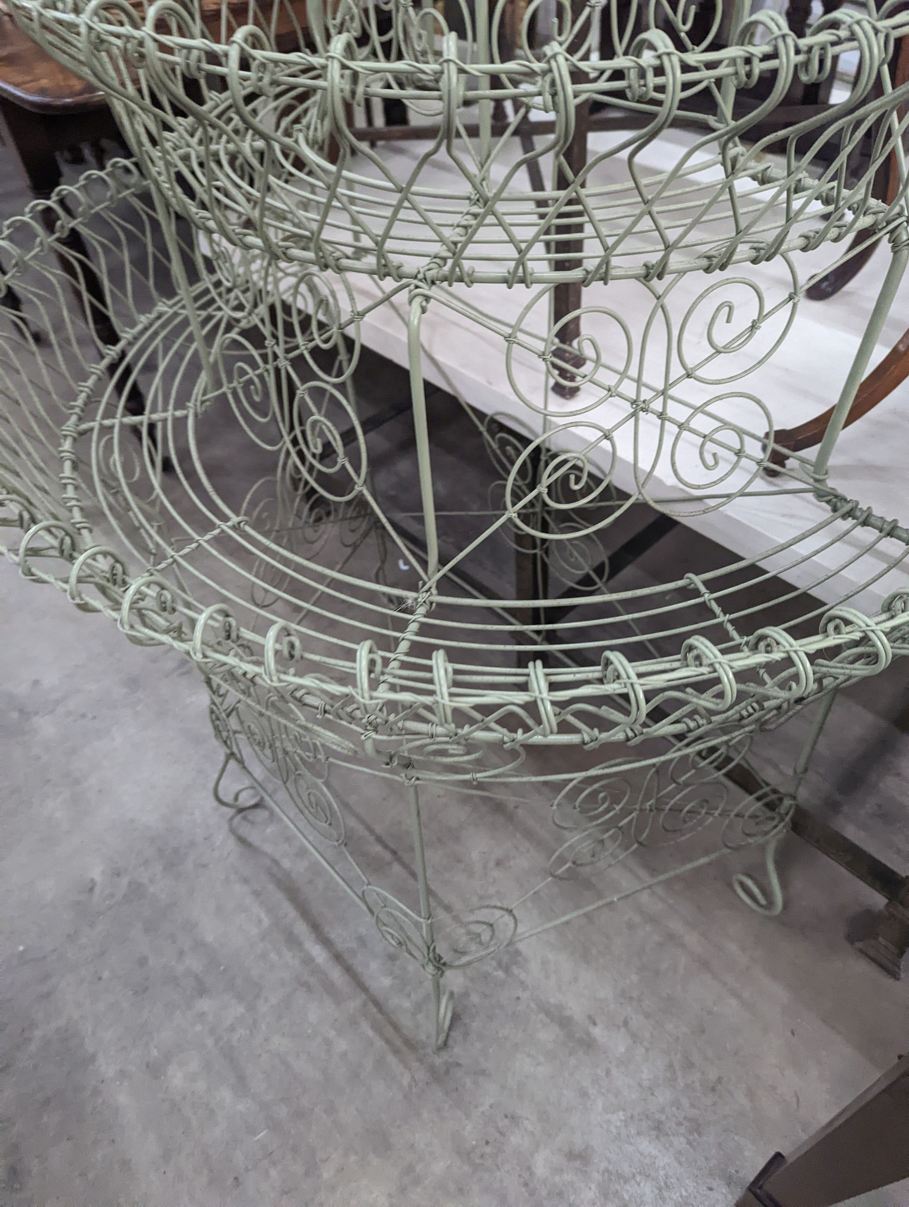 A Victorian style painted wirework plant stand, width 84cm, depth 54cm, height 130cm
